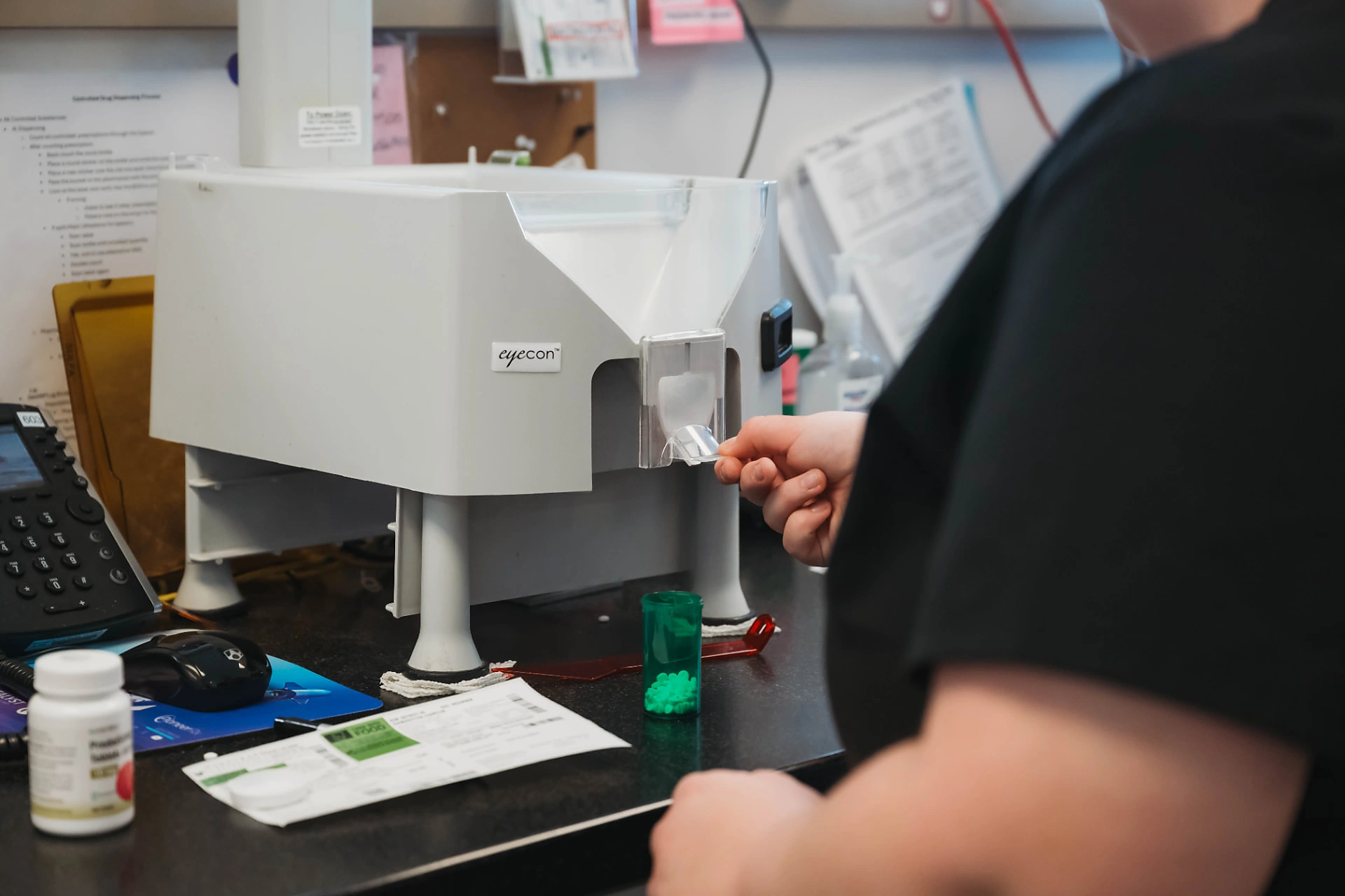 Pharmacy technician using an Eyecon counting machine