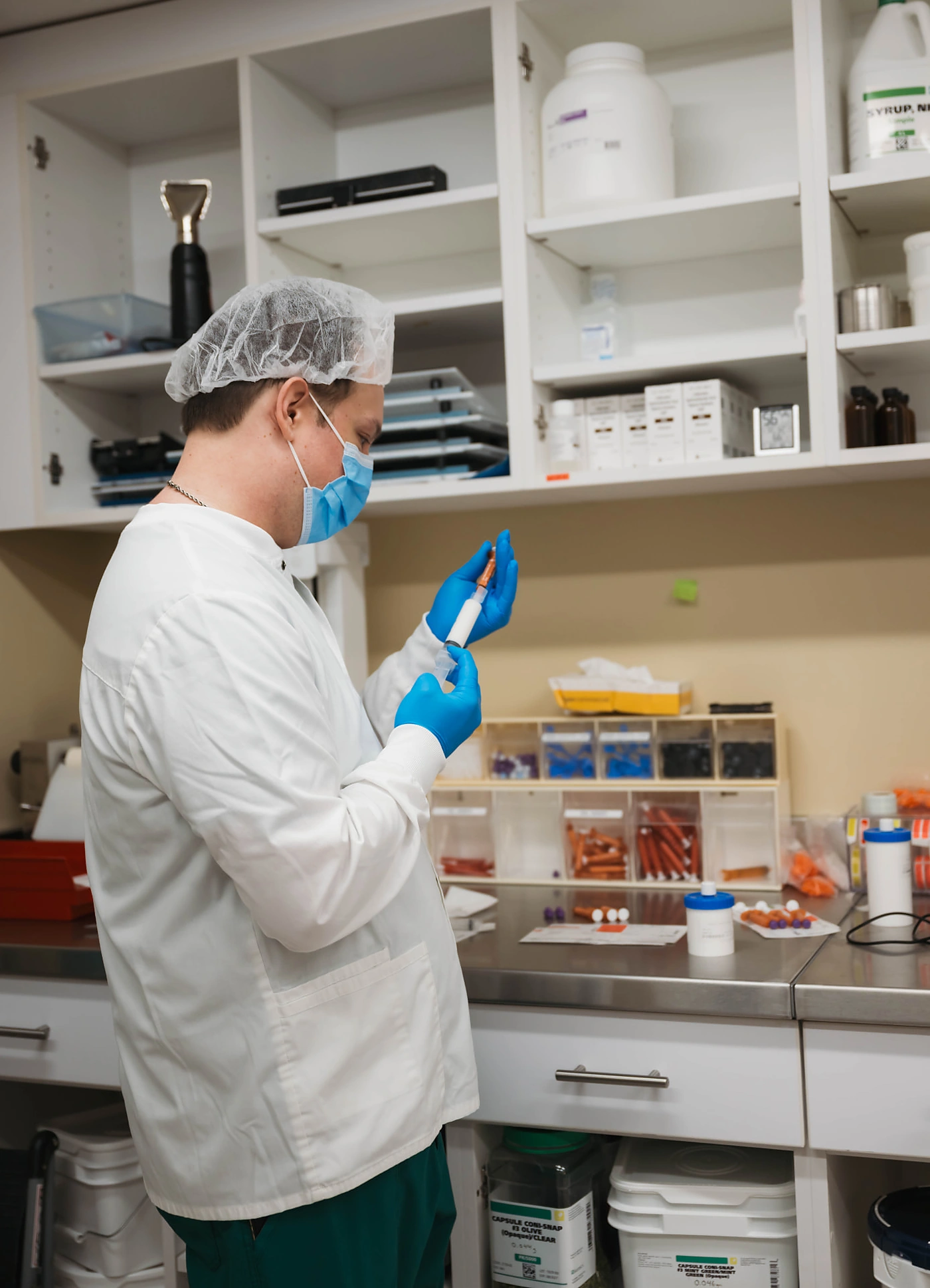 Compounding pharmacist preparing a custom formulation in the Dandurand lab in Wichita, KS