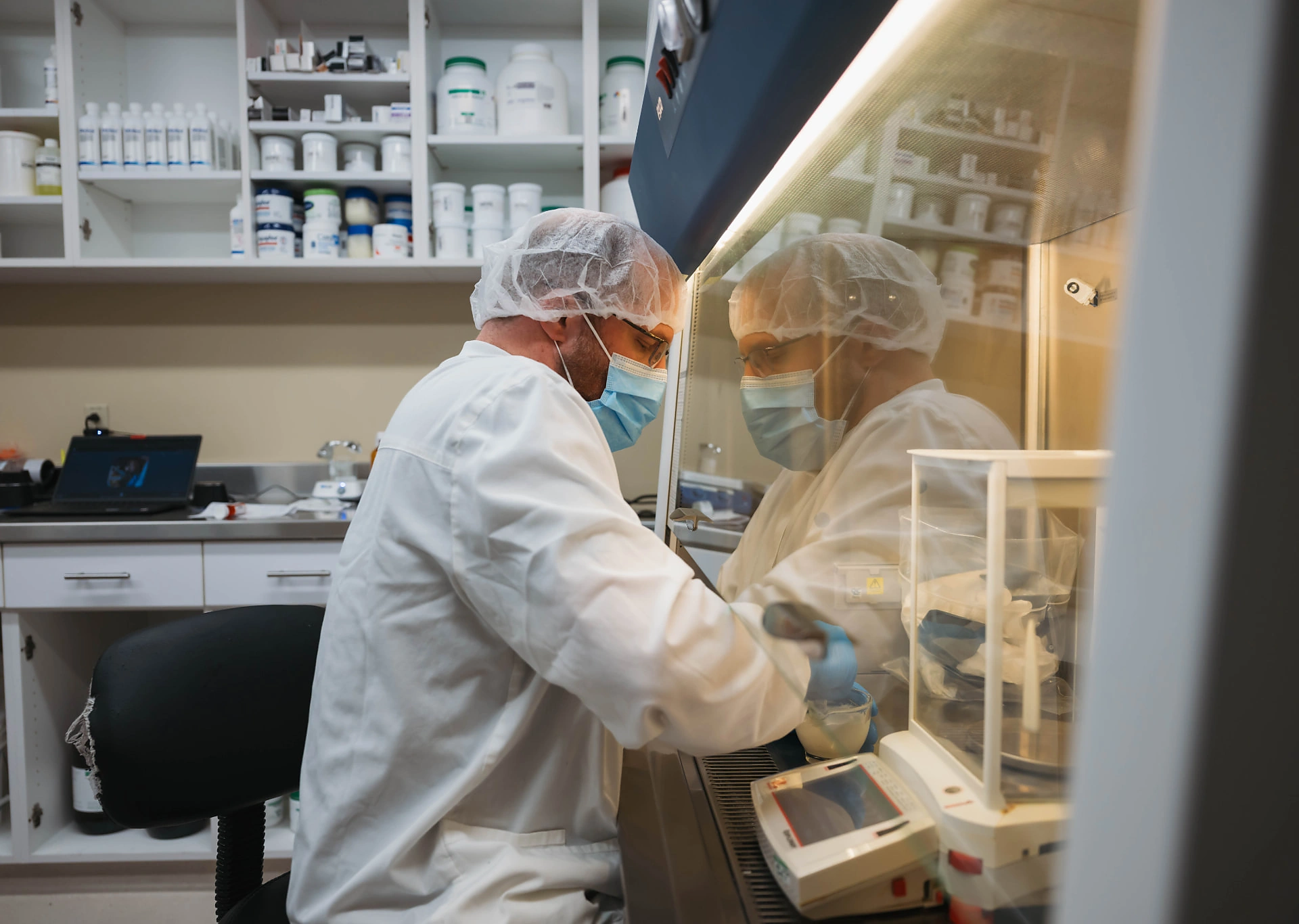 Dandurand pharmacists compounding a preparation under the lab hood in Wichita, KS